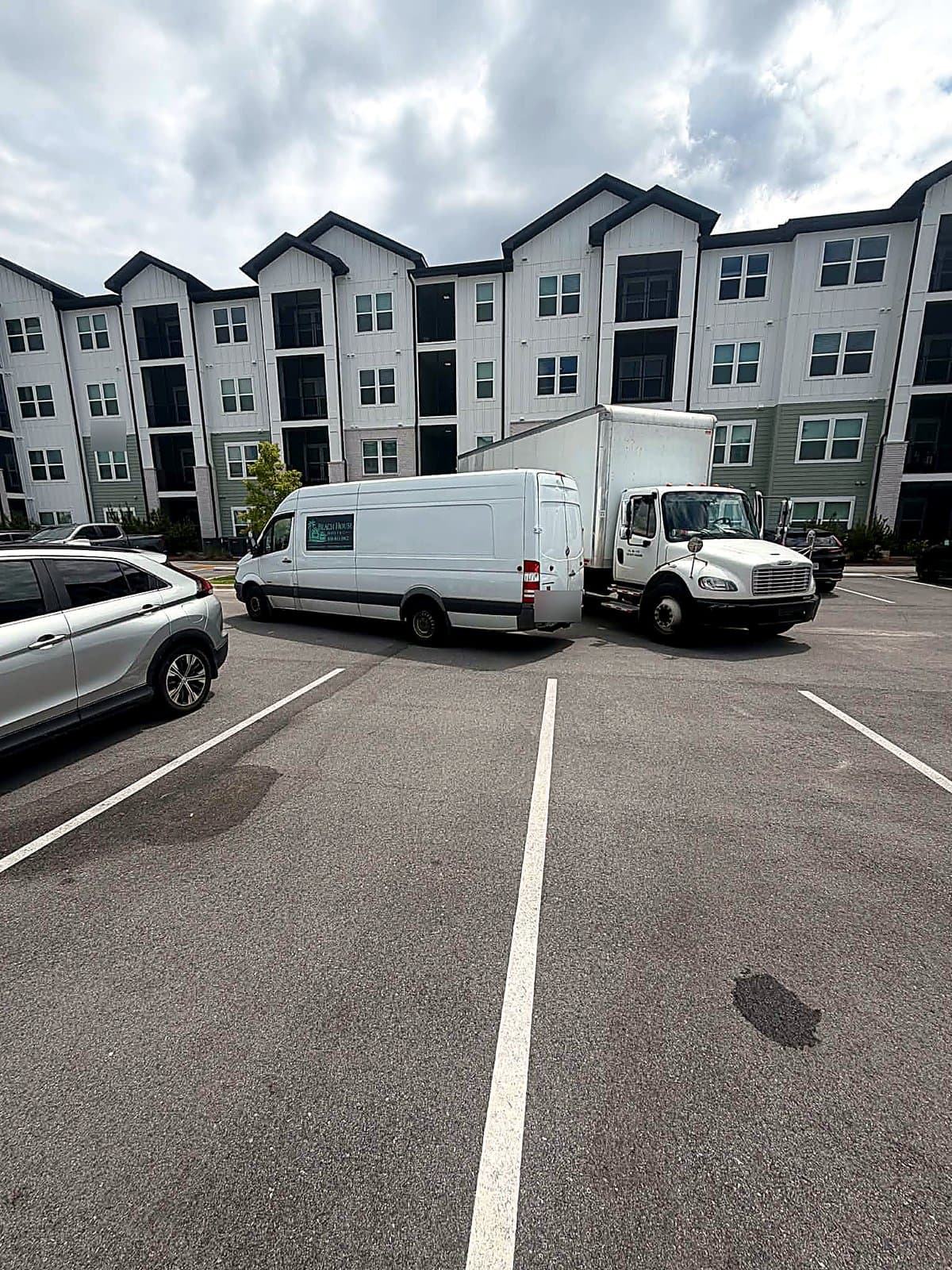 Beach House Moving box truck and Sprinter van staged for an apartment move in Santa Rosa Beach