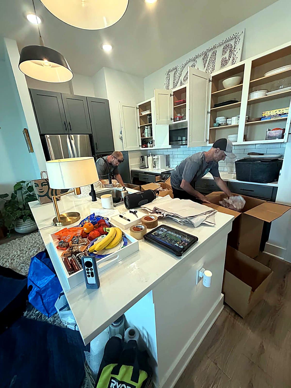Movers wrapping dishes in packing paper during an Inlet Beach, FL kitchen pack