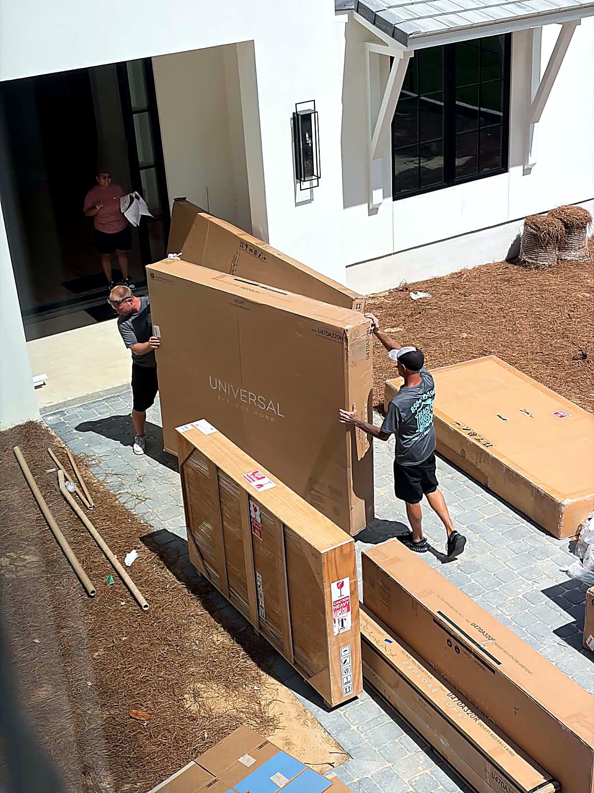 Furniture delivery carried through the front door of a new-construction home