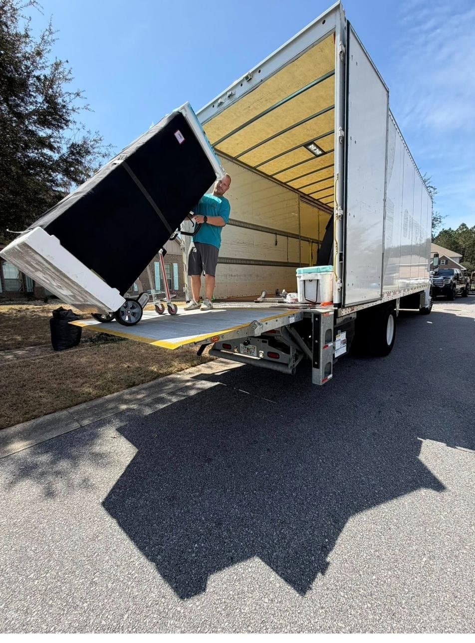 Beach House Moving crew carefully moving a refrigerator