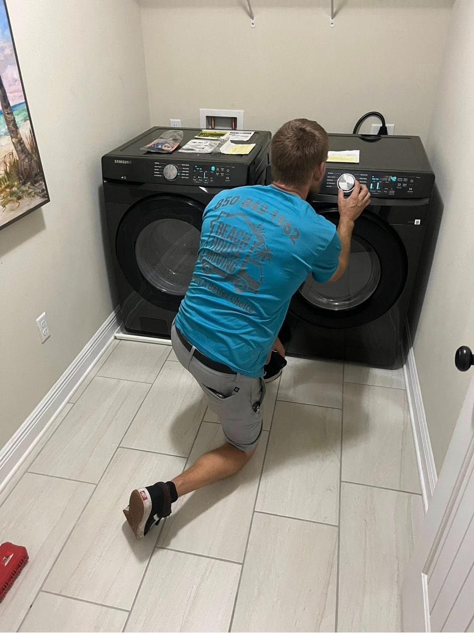Beach House Moving crew moving a washer and dryer