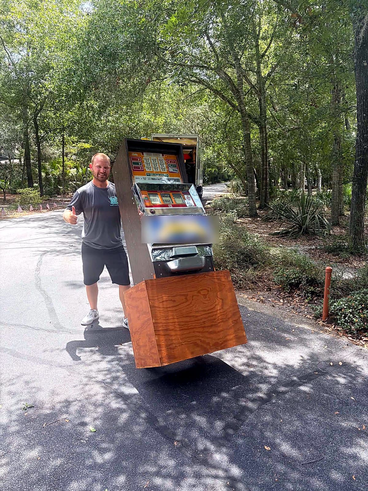 Beach House Moving owner transporting an antique slot machine on a specialty single-item move in Santa Rosa Beach, FL