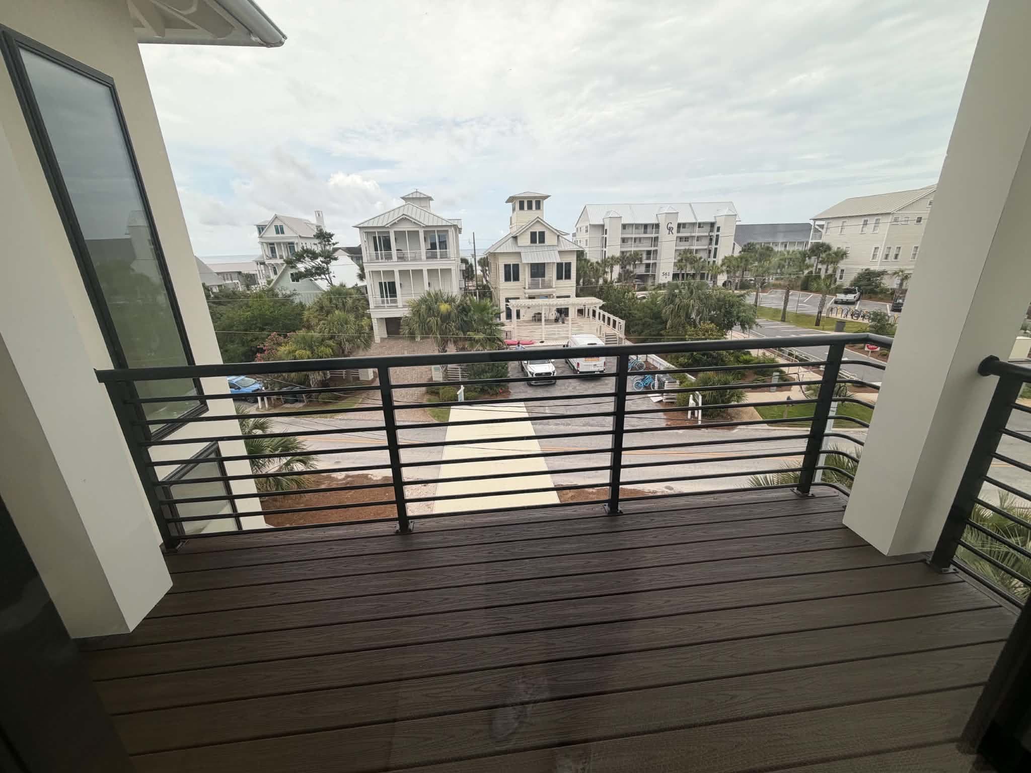 Balcony view over a 30A beach community from a new-construction home served by Beach House Moving