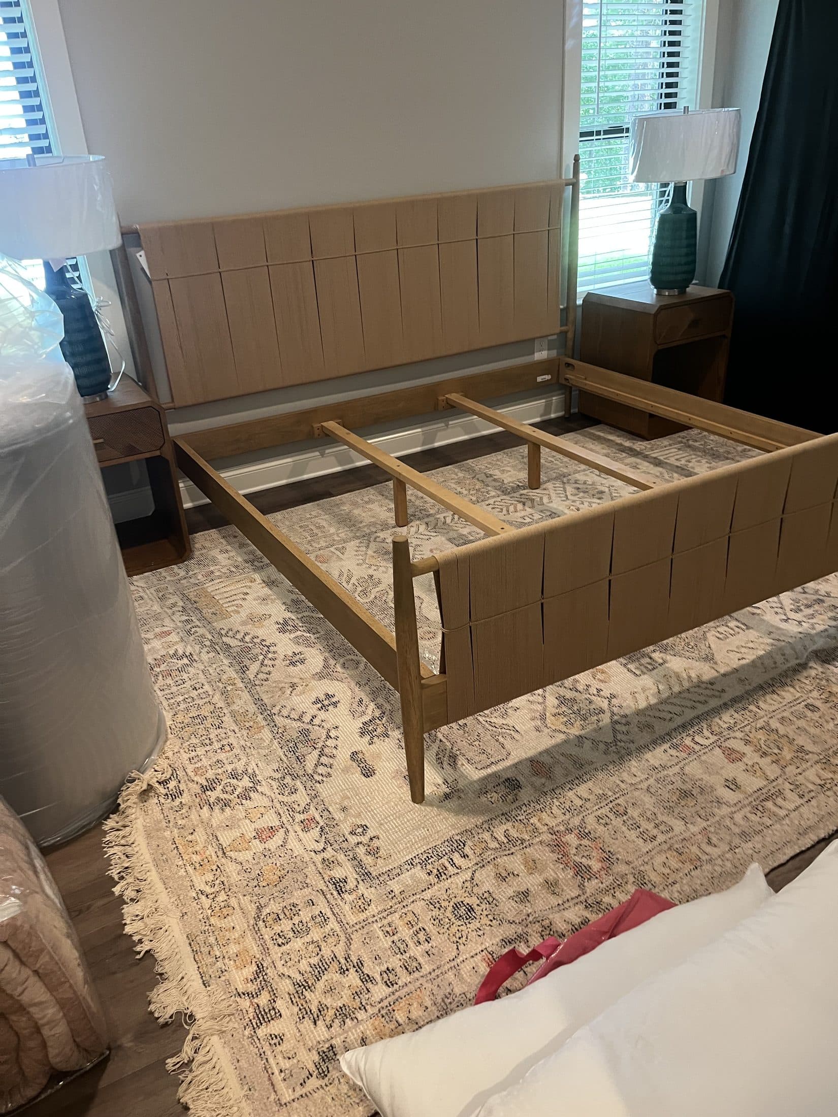 Beach House Moving assembling a bed frame during a primary-bedroom move-in