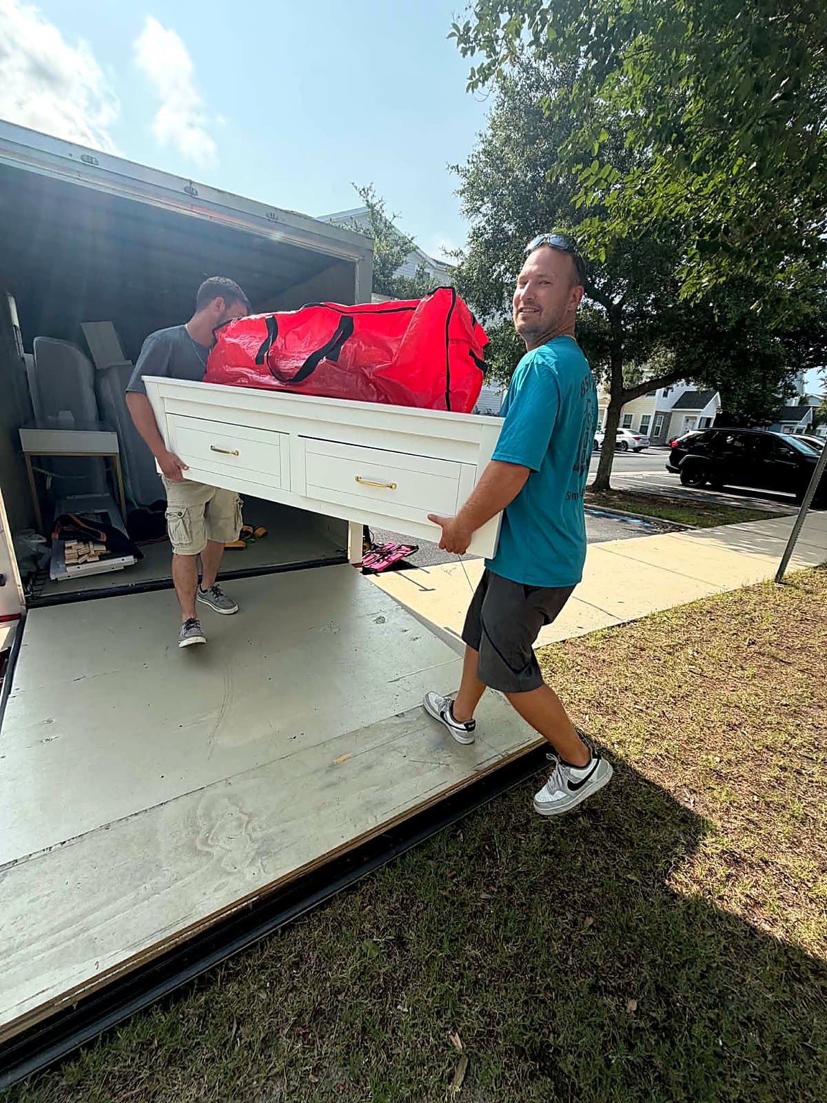 Beach House Moving crew unloading a dresser from the box truck on a local Emerald Coast move
