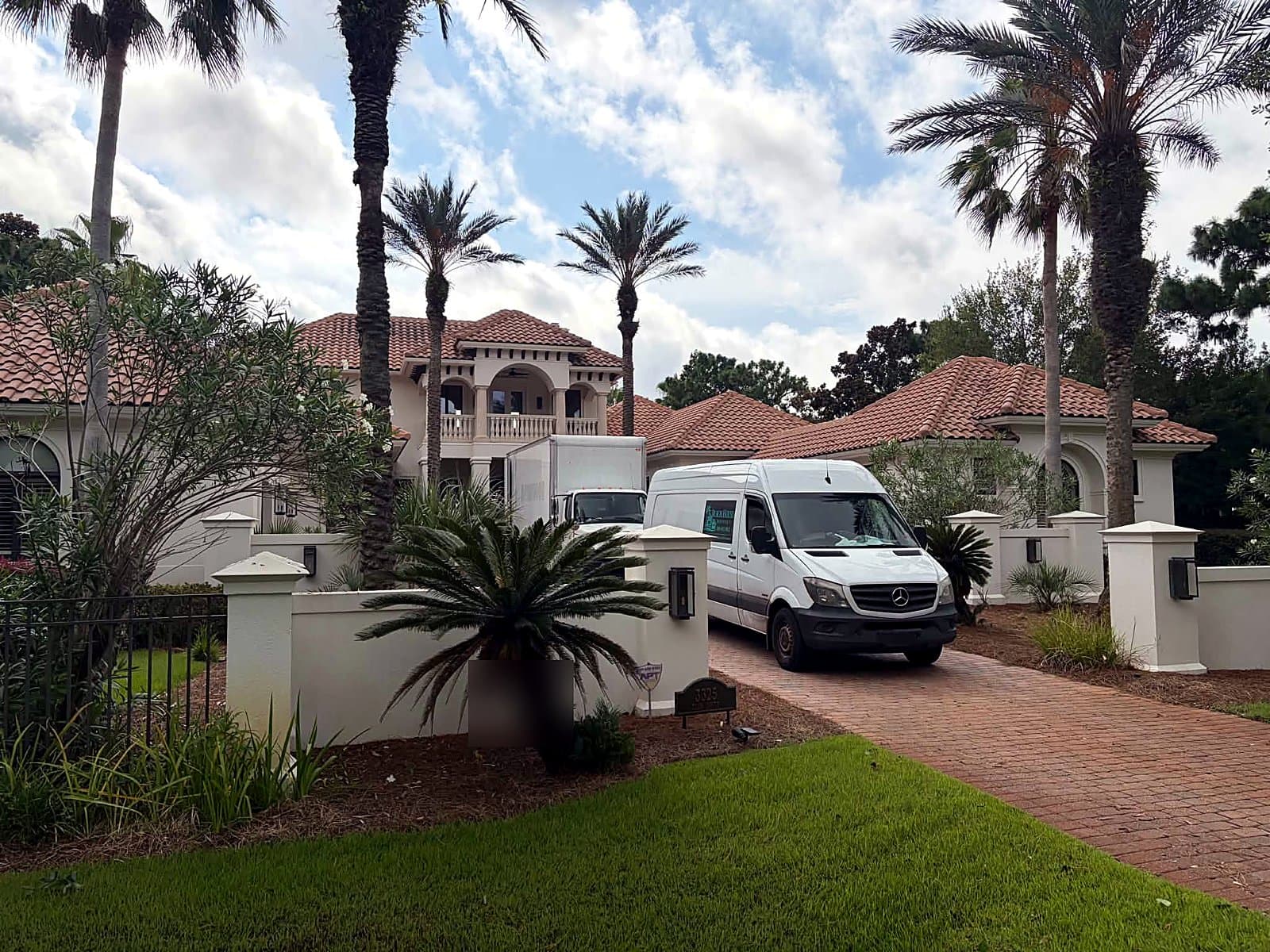 Beach House Moving box truck and Sprinter van staged at a luxury Florida Panhandle home