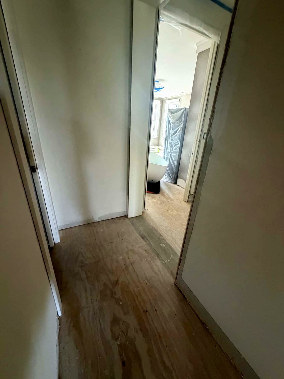 Narrow hallway and door opening measured for a freestanding tub delivery in a Seacrest Beach, FL home under construction